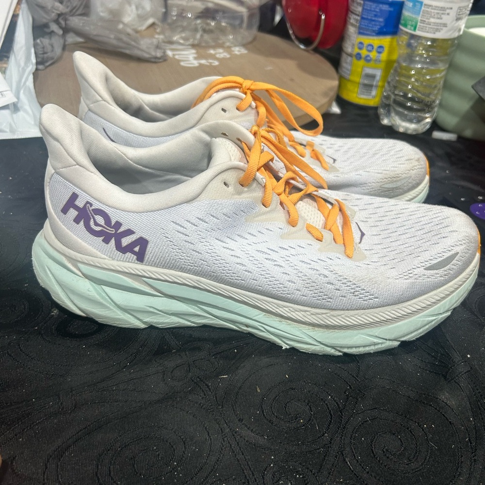 Hoka Women’s White Sneakers with Mint Sole and Orange Laces